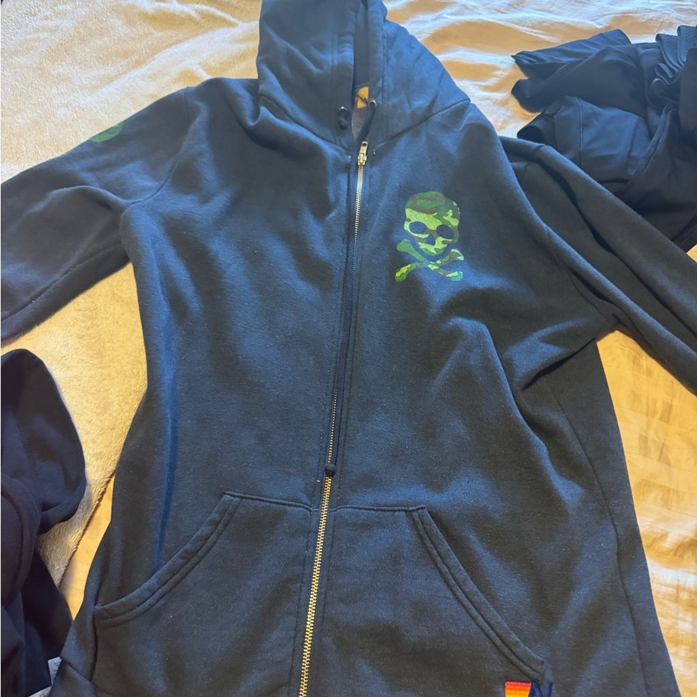 Aviator Nation Blue Hoodie with Green Skull Design